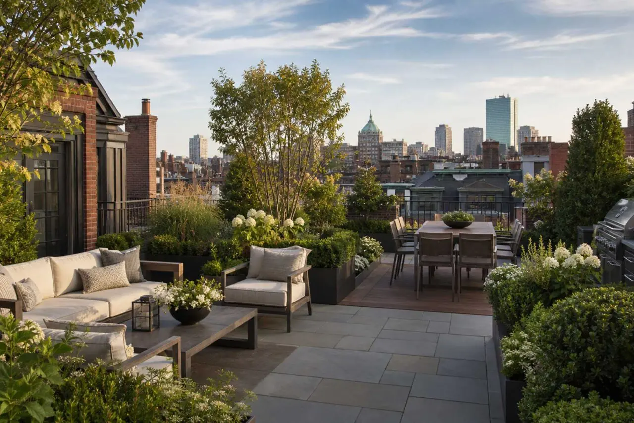 Boston, MA - An elegant urban rooftop terrace featuring layered gardens, comfortable lounge and dining areas, and sweeping views across the city.