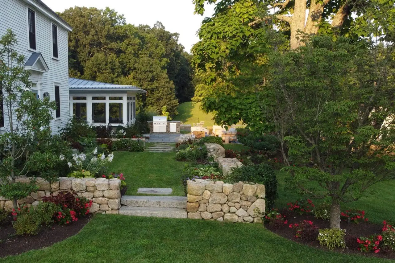 Carlisle, MA - Raised garden beds and stone steps integrated with natural plantings, creating a functional and sustainable transition through the landscape.