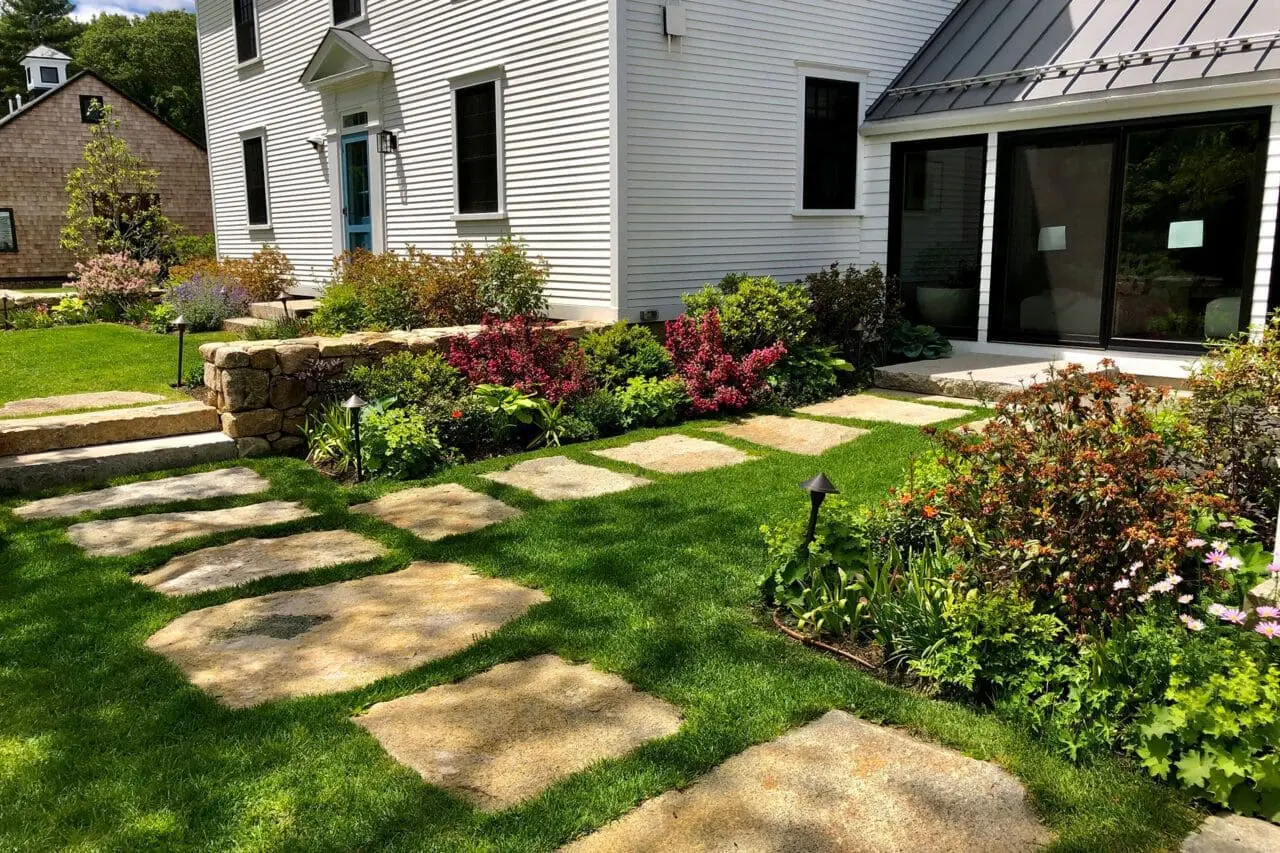 Carlisle, MA - A stone walkway integrated into a natural landscape, using durable materials and surrounding plantings to create a functional, low-impact garden path.