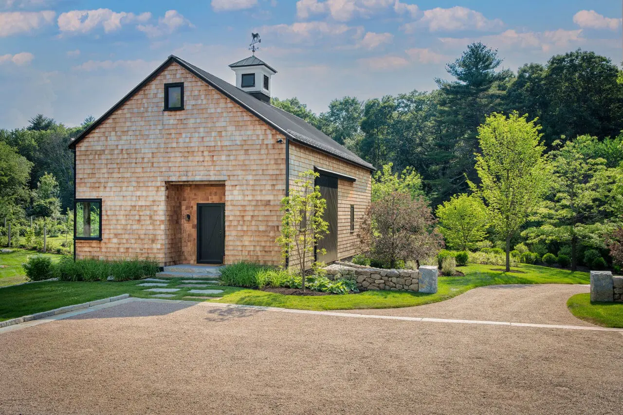 Carlisle, MA - A gravel drive leads to the converted barn, blending modern use with traditional landscape materials.