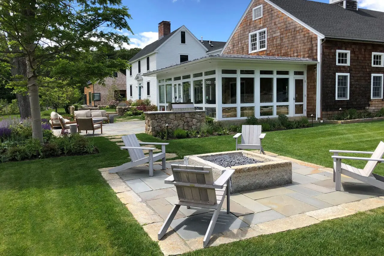 Carlisle, MA - Layered stone steps guide movement through planted slopes, managing grade while adding architectural interest.