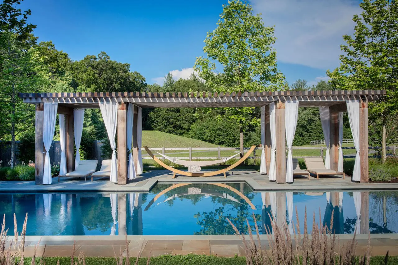 Carlisle, MA - A pergola aligns with the pool’s axis, creating reflection, balance, and a strong visual focal point within the broader landscape.