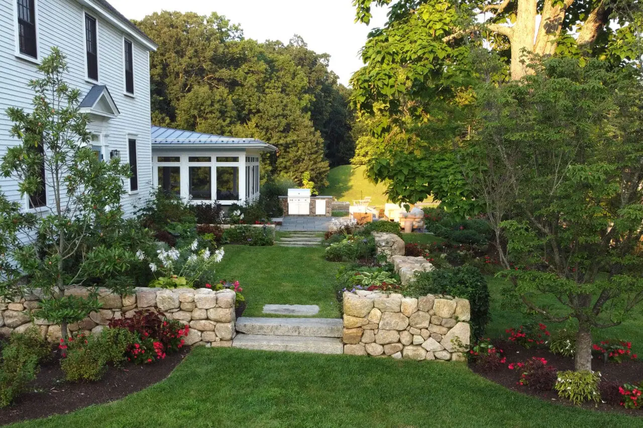 Carlisle, MA - Stone steps connect a screened porch to the garden terrace, extending living space while maintaining a seamless indoor-outdoor relationship.