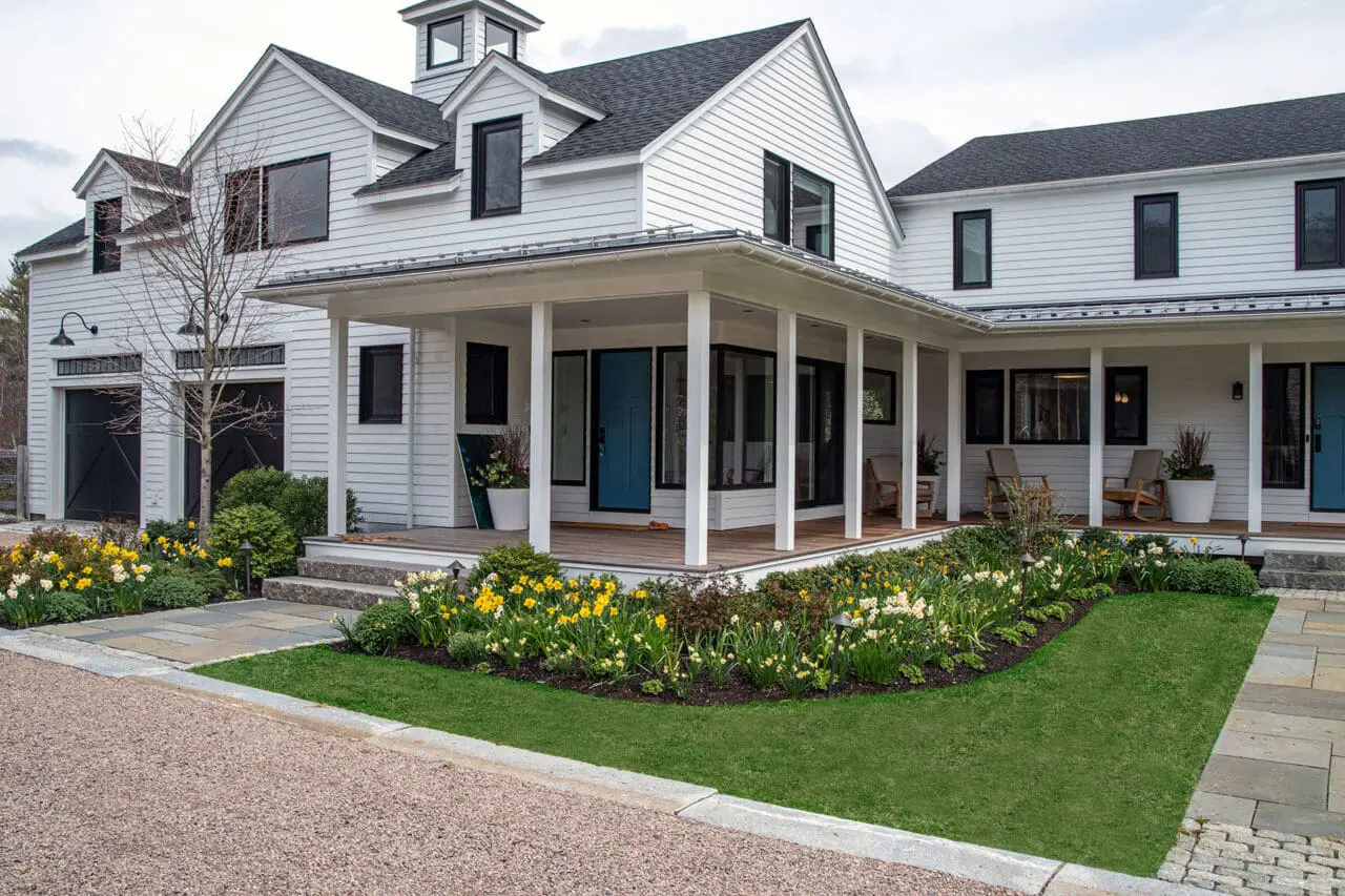 Carlisle, MA - Foundation plantings and paths wrap the porch, creating a welcoming transition between home and garden.