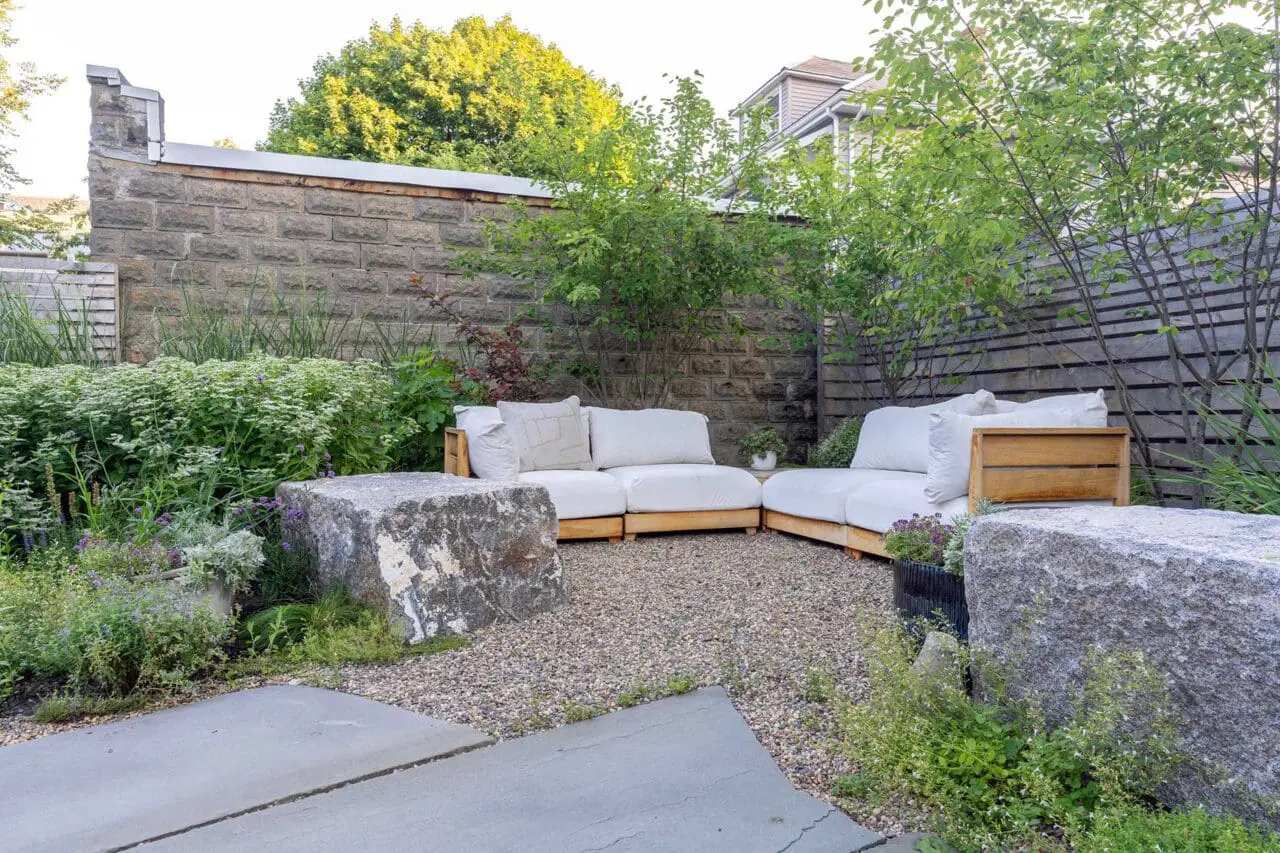 Cambridge, MA - A gravel seating area framed by reclaimed stone blocks offers a more intimate retreat, with native plantings providing texture and seasonal variation. Photo credit: Dan Kaplan