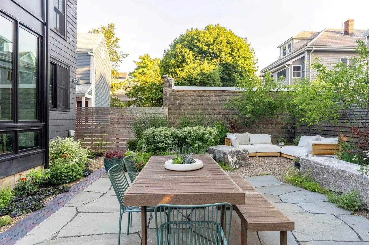 Cambridge, MA - The dining terrace is positioned to connect directly to the home, with bluestone paving and layered plantings creating a cohesive and usable outdoor room. Photo credit: Dan Kaplan