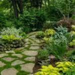 Brookline, MA - A lush woodland garden with a winding stone path, layered foliage, and shade-loving plantings, featured by Martha Stewart for its charming, naturalistic design.