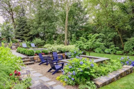 Wellesley, MA - This gravel fire pit terrace is softened by hydrangeas and layered planting, offering a relaxed gathering space set slightly apart from the pool. photo credit: Michael J Lee
