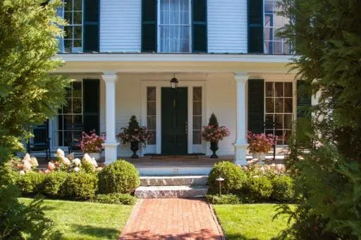 Belmont, MA - Boxwood and hydrangea frame antique granite steps to the home's main entrance.