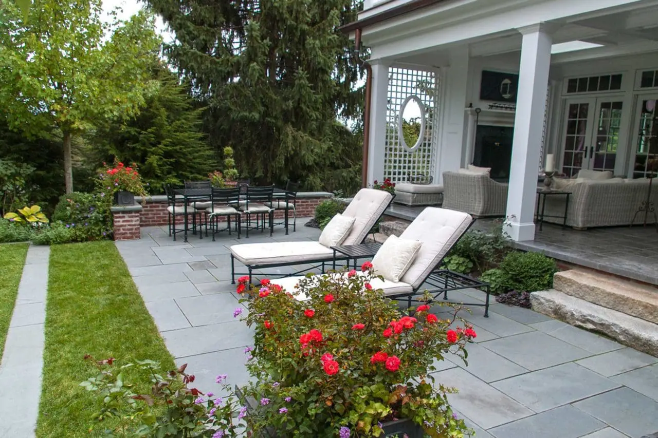 Belmont, MA - A seating wall edges the bluestone patio providing ample space for dining or lounging.