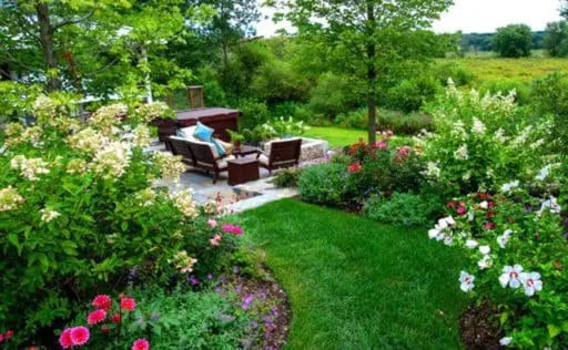 A butterfly garden surrounds the country farmhouse with nectar-rich flowers and layered plantings designed to attract butterflies and other pollinators.