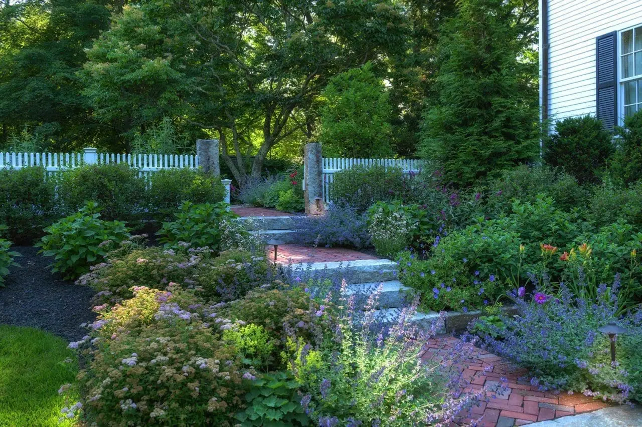 Lincoln, MA - This Lincoln garden pairs lush planting beds with natural stone edging for a refined, well-structured New England landscape.