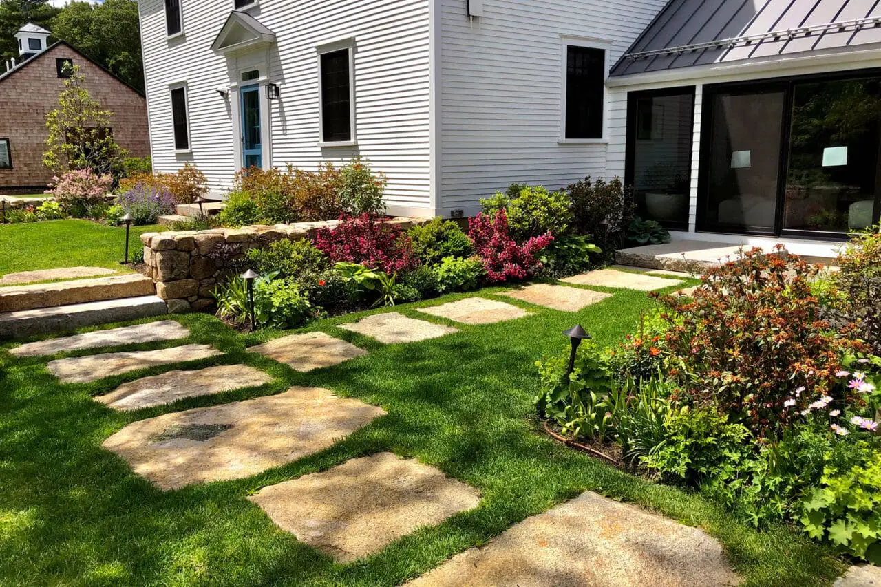 Carlisle, MA - Granite stepping stones create a durable lawn path that supports casual garden circulation without overwhelming the landscape.