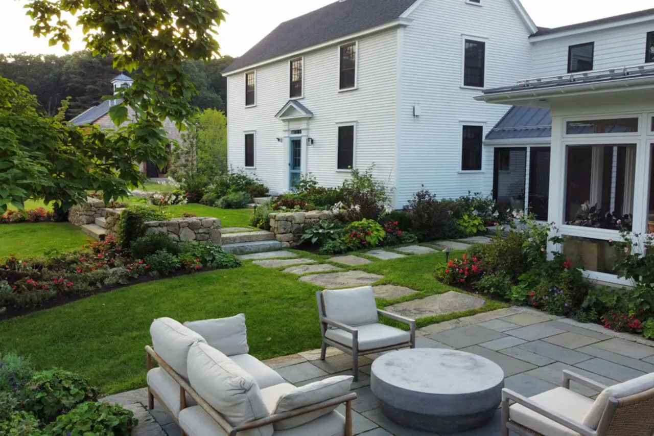 Carlisle, MA - Large stone steppers form a relaxed front walkway, balancing durability with a lighter footprint that softens the home’s formal architecture.