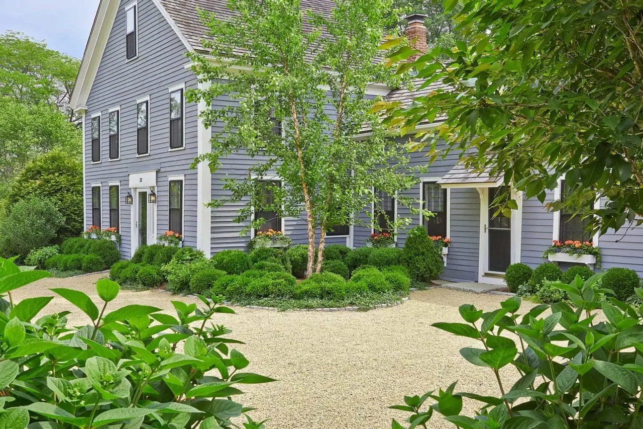 Wayland, MA - Elegant New England gardens and window boxes accent the property. The pea stone driveway welcomes guests and softens the home's entryway. Photo: Charles Mayer