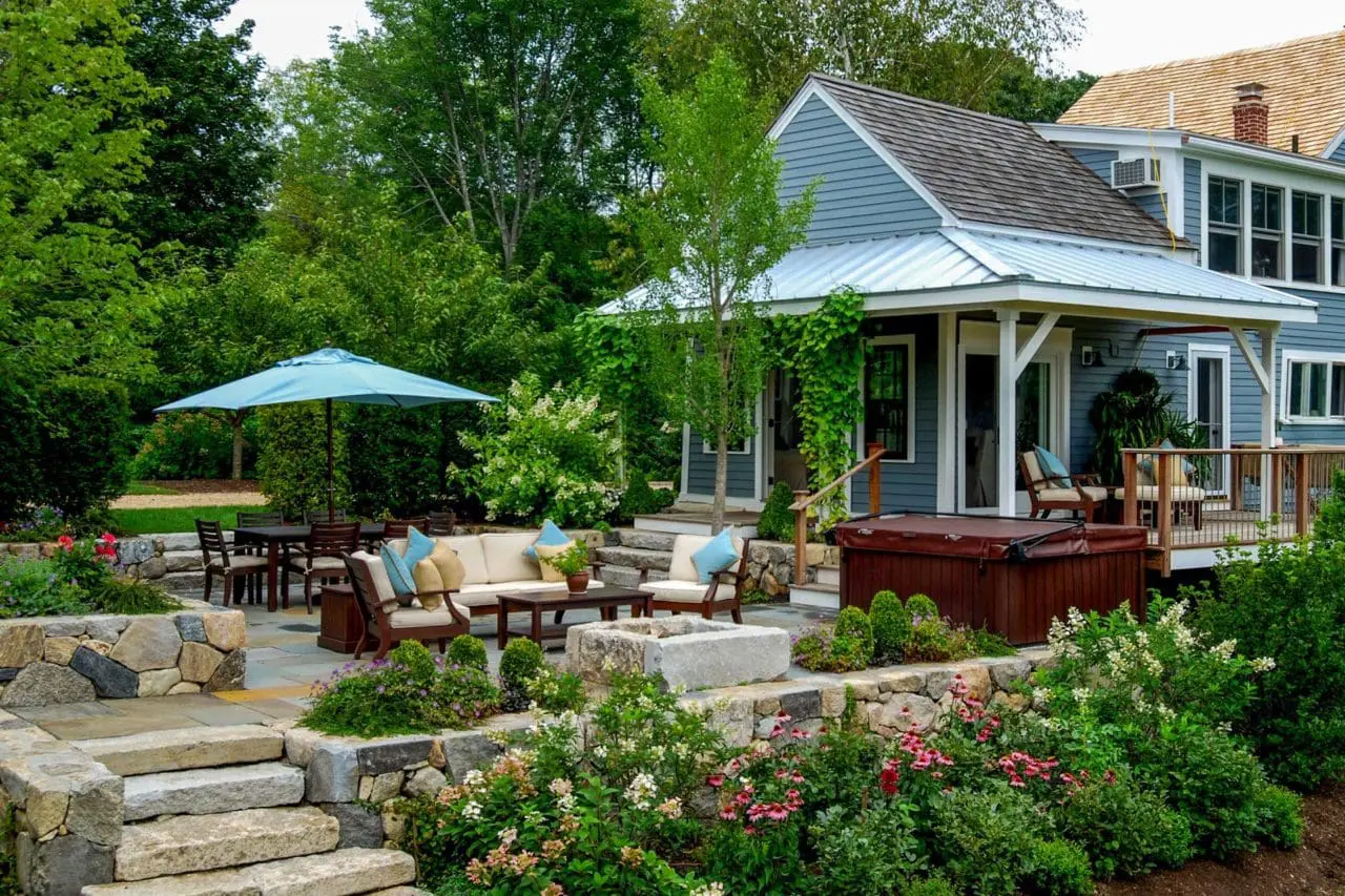 Wayland, MA - The farmhouse's covered porch transitions an indoor mudroom to the sunken patio.