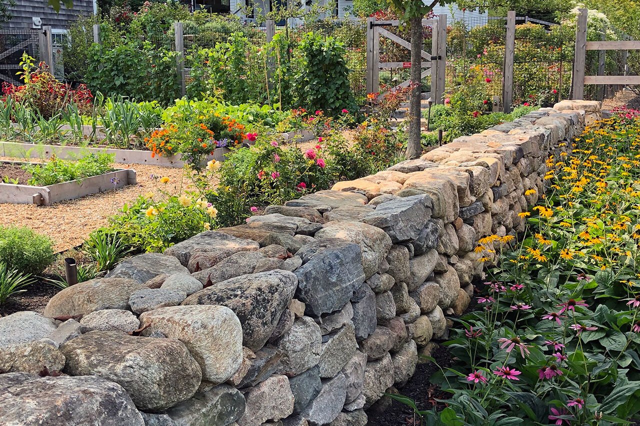 Carlisle, MA - Native plantings soften a stone garden wall, supporting biodiversity while maintaining a refined, estate-appropriate aesthetic.