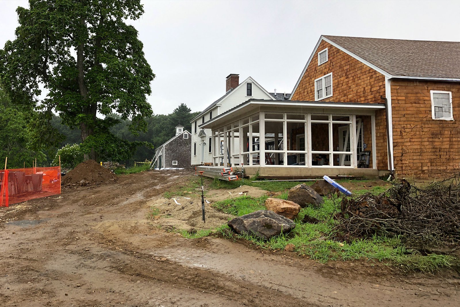 Before photo of a Carlisle backyard with simple patio and lawn prior to landscape renovation