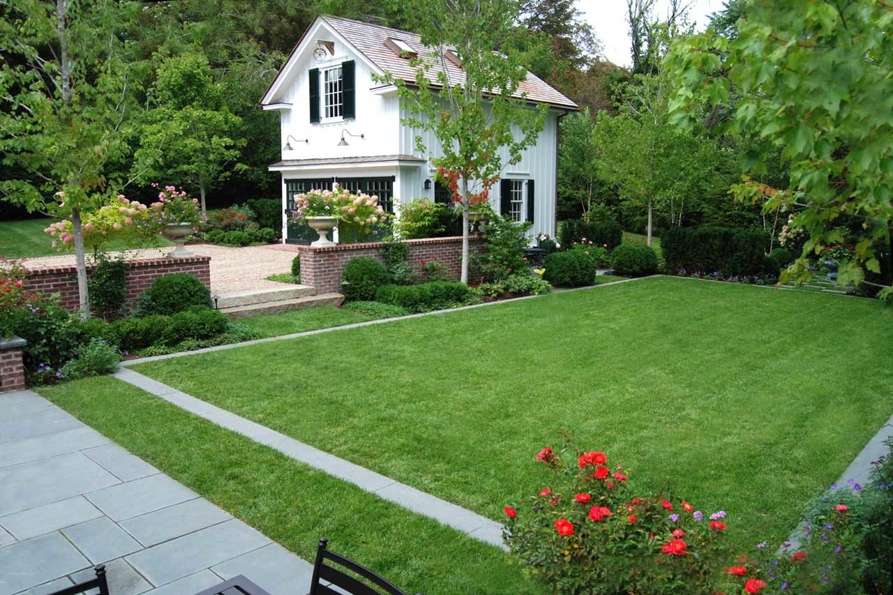 Belmont, MA - The bluestone band reflects the patio and frames a lush lawn space.