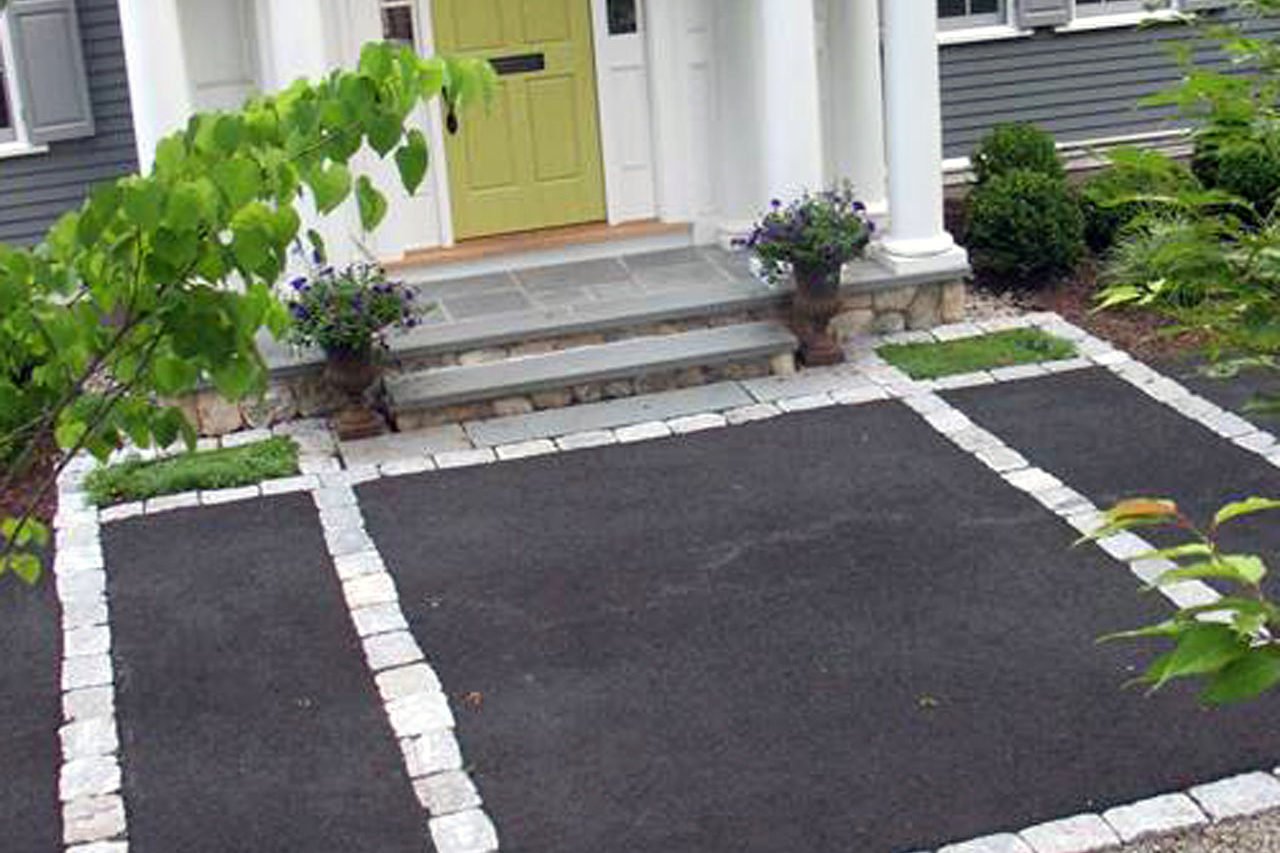 The cobblestone inlay courtyard adds a classic accent while pulling the landscape and residence together.