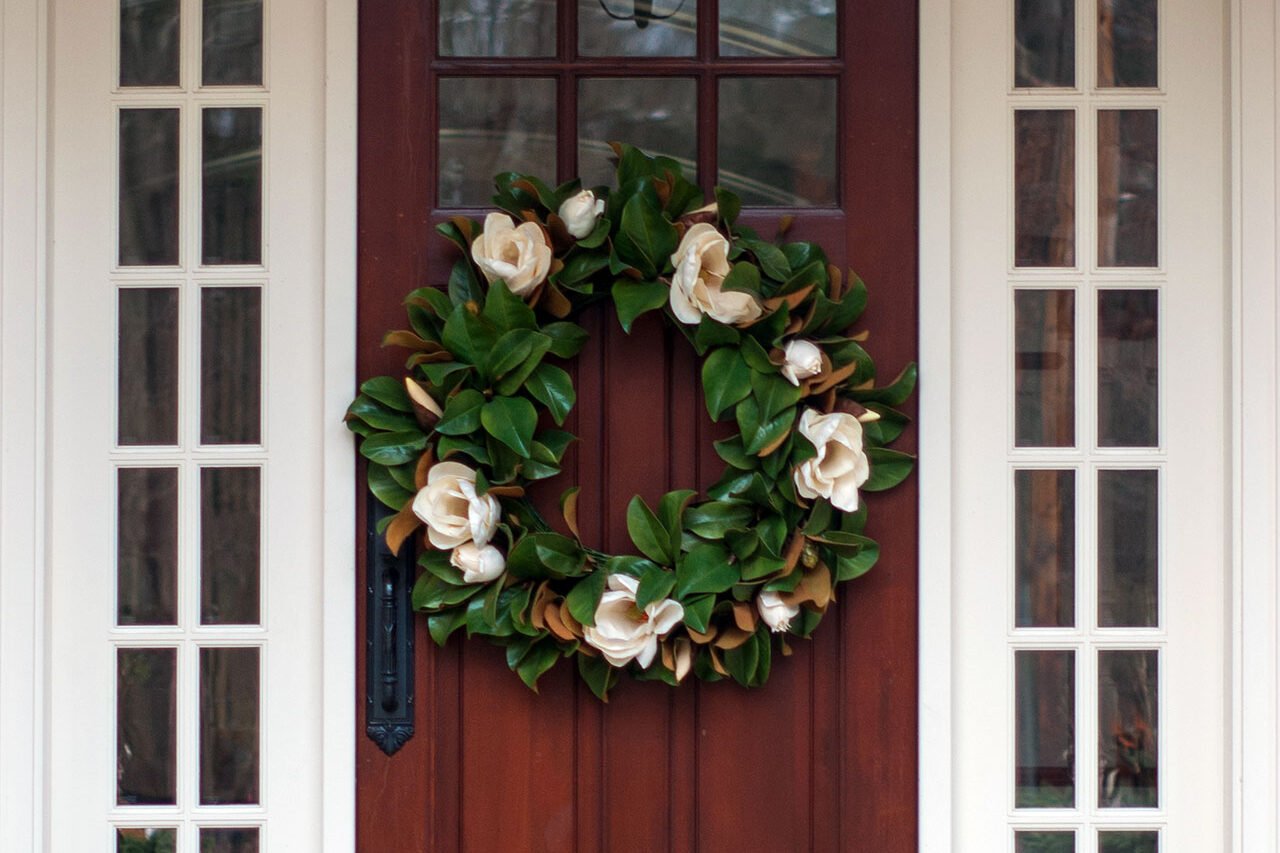 Magnolia leaves offer a refined palette of green and bronze, adding quiet elegance to a formal entryway during the holidays.