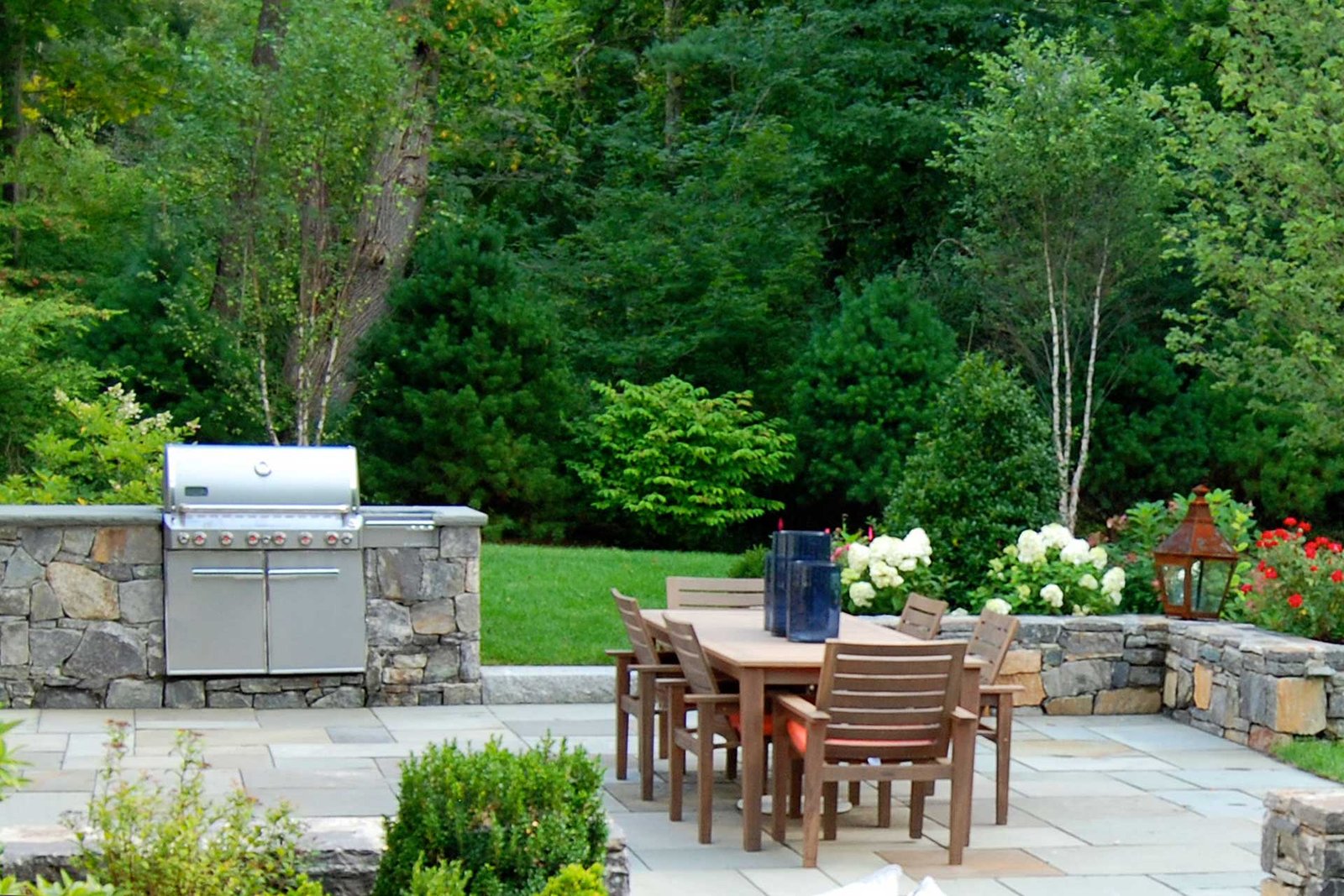 Dover, MA - Corinthian Granite walls enclose the bluestone cooking and dining area.