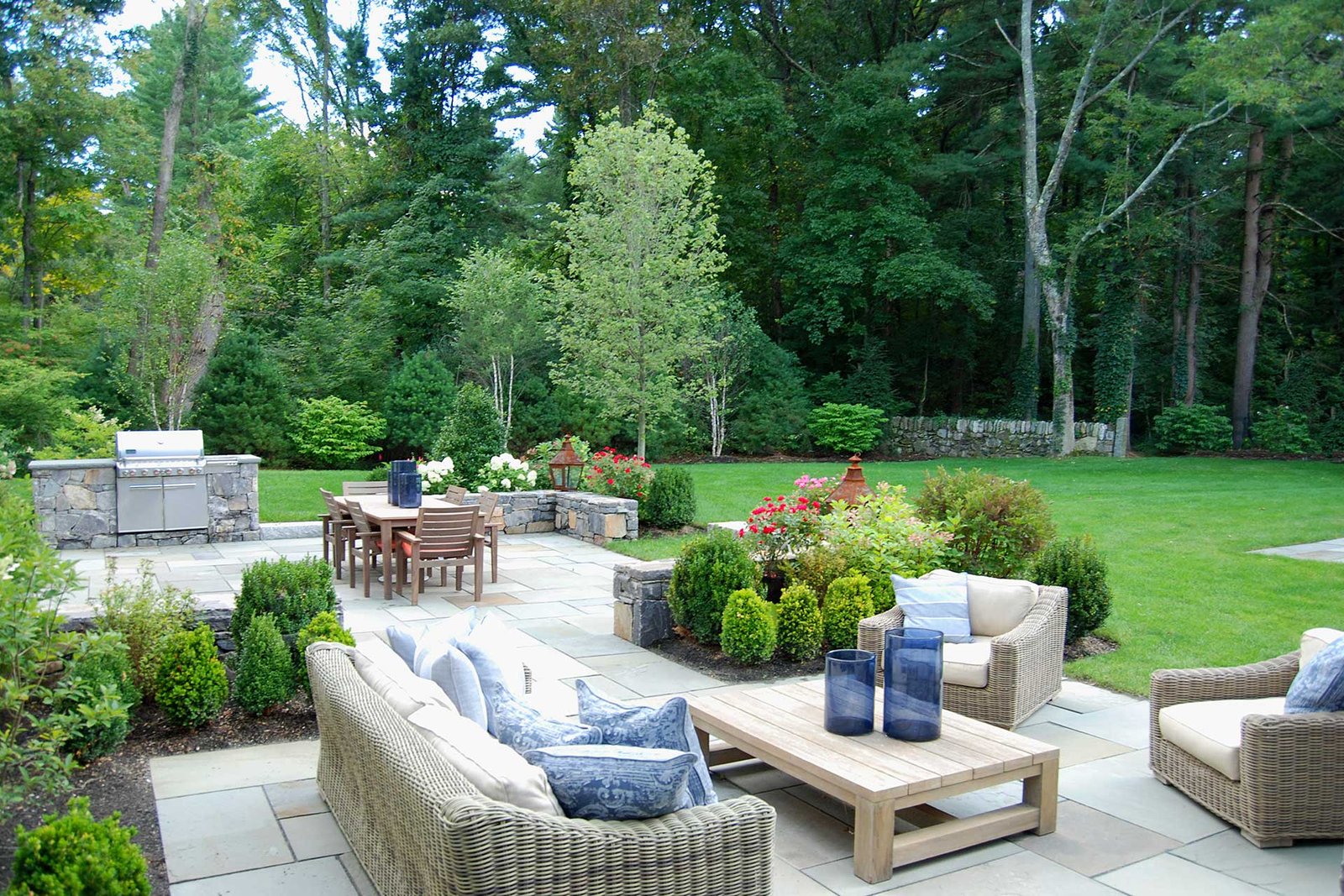 Dover, MA - A lush lawn contrasts stone surfaced dining and seating areas.