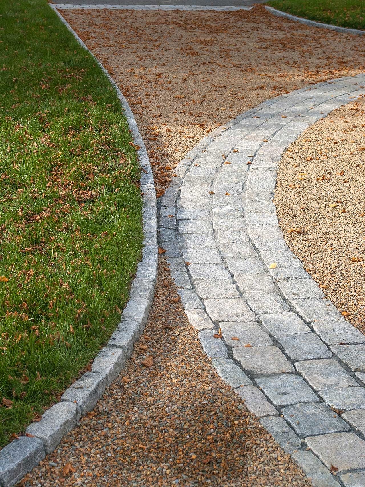 Duxbury, MA - Granite edging and inlays help define the circular drive.