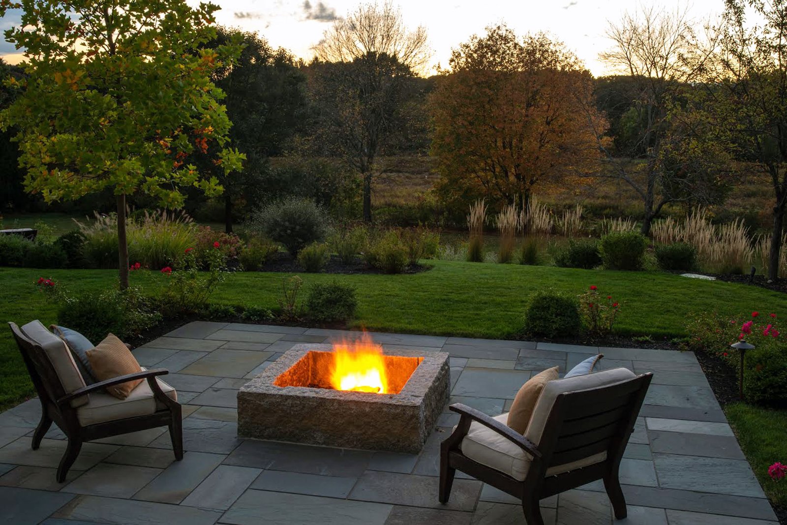 This low-profile stone fire pit fits neatly into a terraced patio, delivering warmth and visual interest without interrupting sightlines or overwhelming the surrounding landscape.