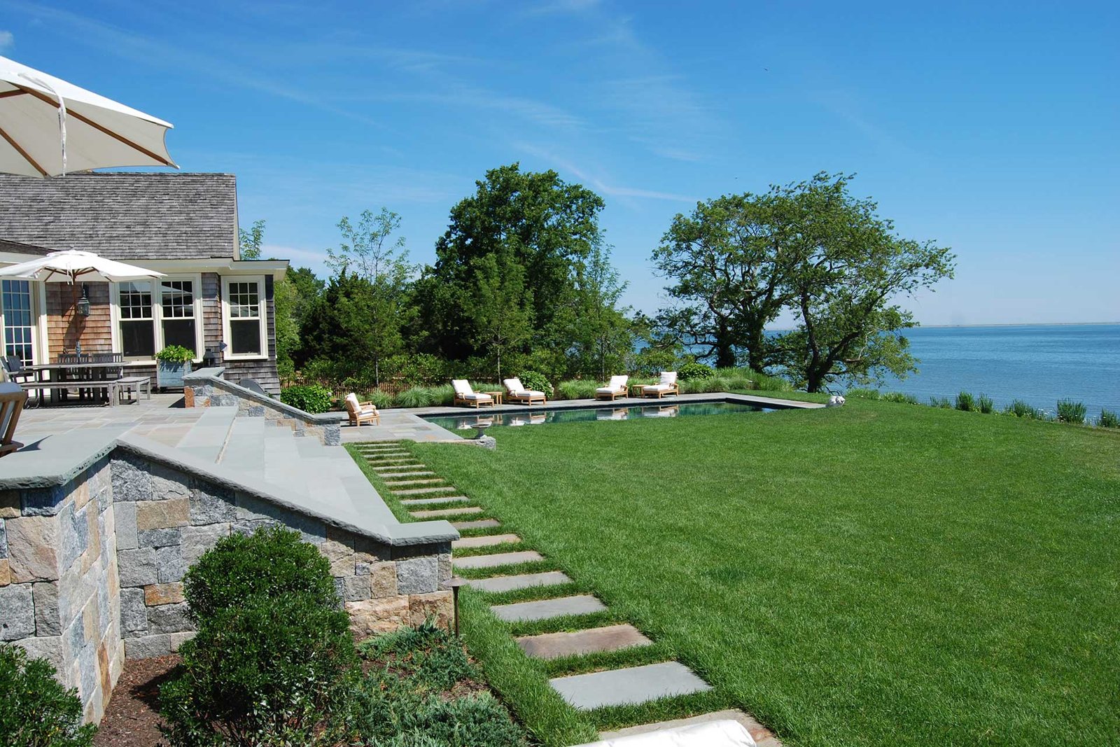 Duxbury seaside estate with pool, lawn, and ocean view