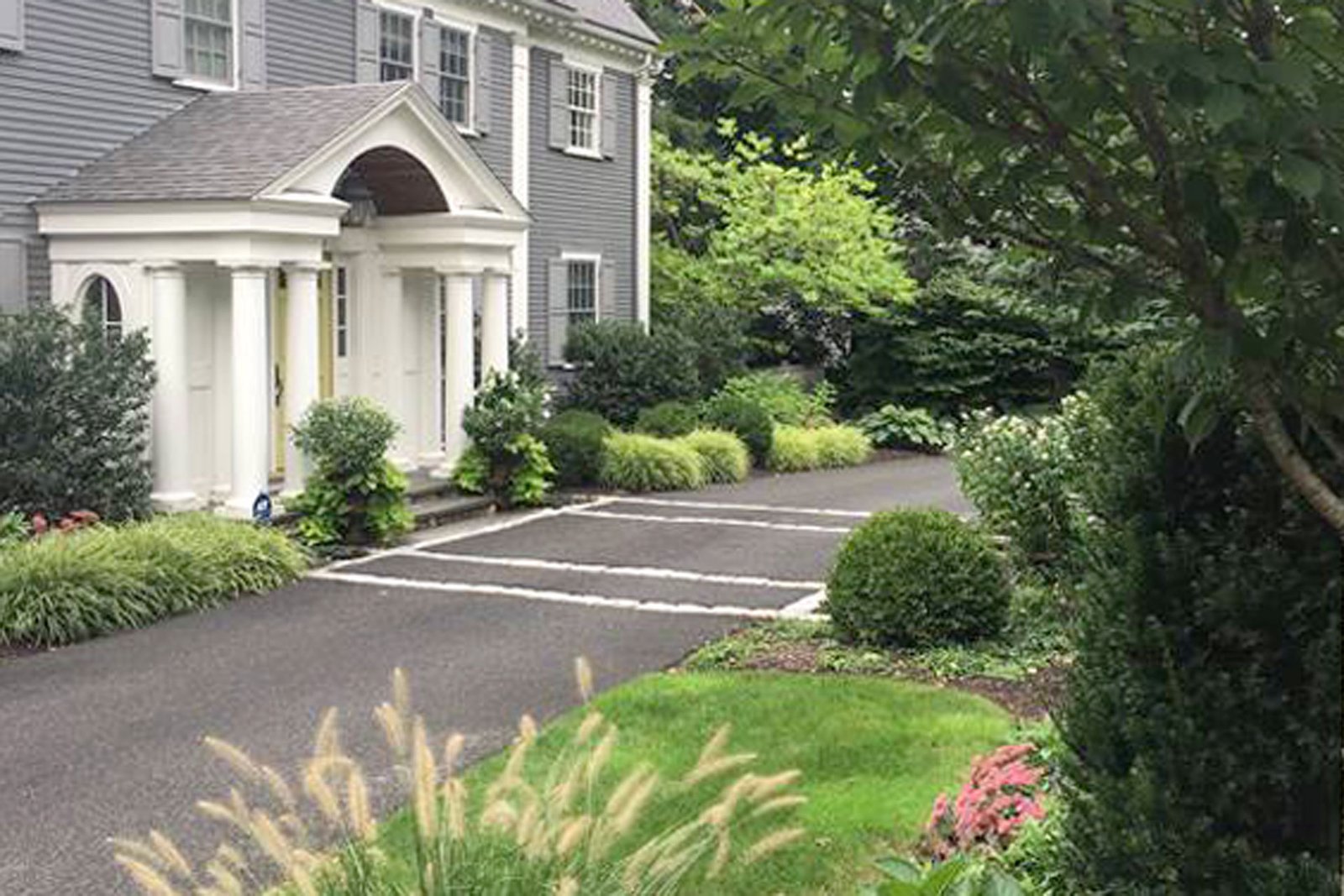 Wellesley front border after evergreen hedge, cherry trees, and perennial planting