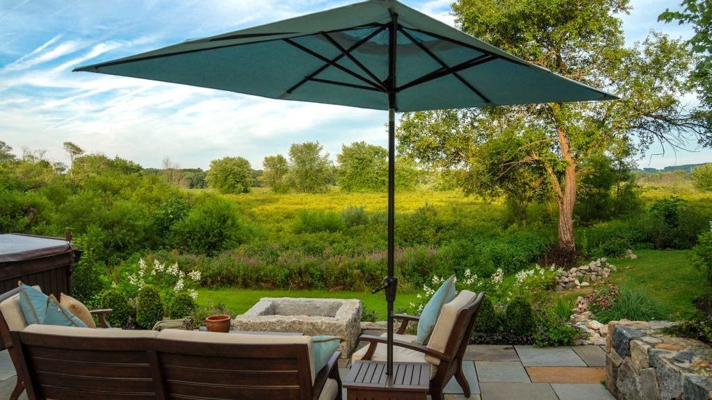 Wayland, MA - A pristine view of the Sudbury River from the new patio, complete with furniture and fire pit.